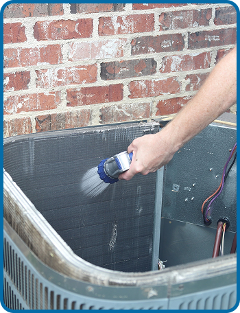 AC coil being cleaned